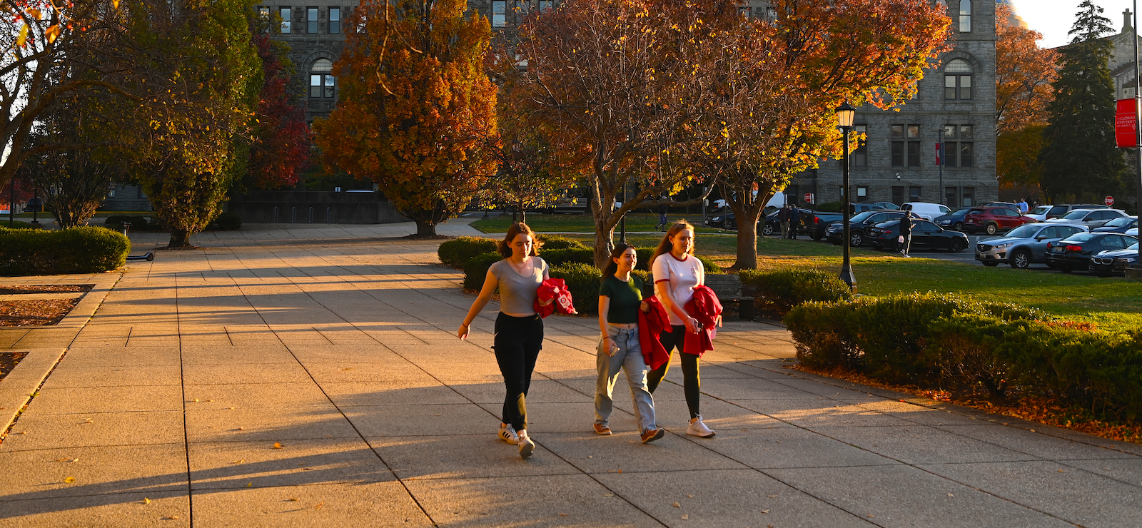girls walking through campus in the fall